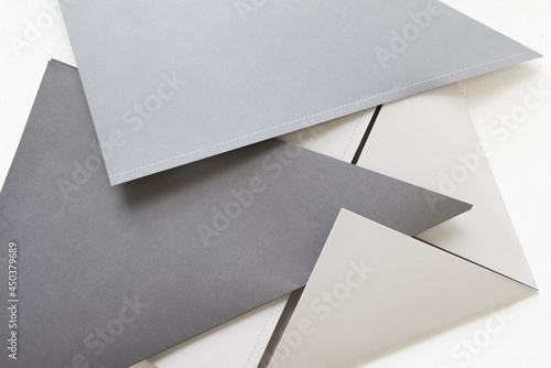various gray papers folded in half on a light background © eugen