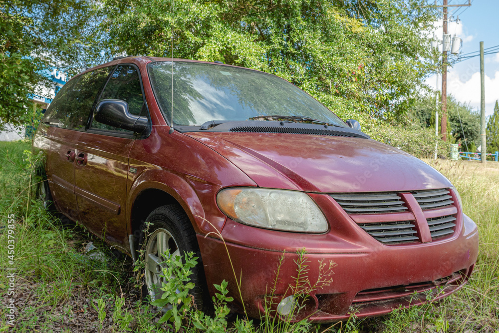 Abandoned mini van in a field Abandoned mini van in a field