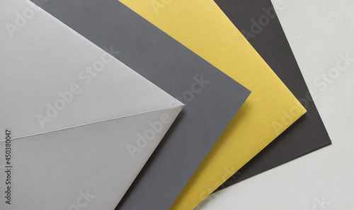 pale yellow construction paper with various shades of gray paper background