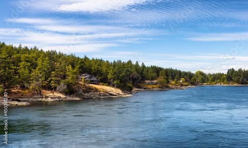 Panoramic View of a Cosy Homes on the rocky coast during a sunny summer day. Taken on Galiano Island near Vancouver Island, BC, Canada. © edb3_16