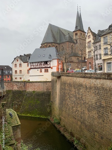 Saaburg, Germany, May 25, 2020. The city is located on the Grundbach stream, which flows into the Saar River. Buildings built on a stone wall separating the flow of water from city buildings. 
