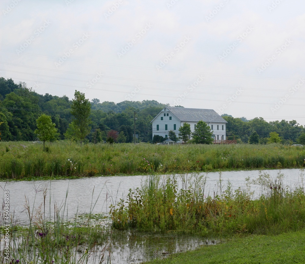 The building in the park near the pond on a sunny day.