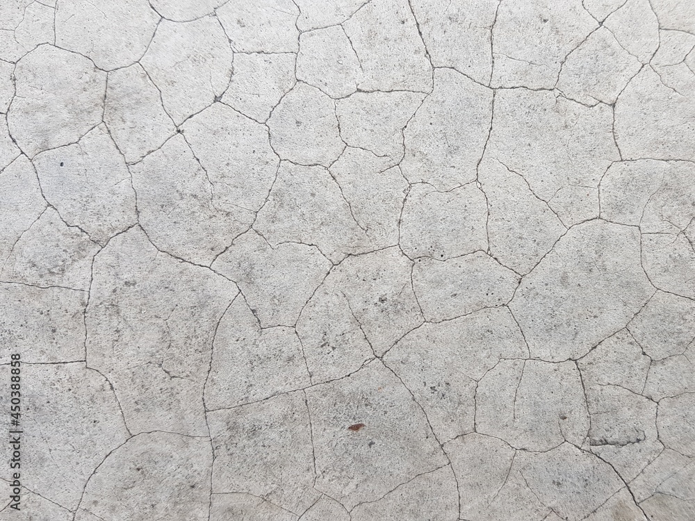 Cracks on the white concrete pavement. Cracks on the white concrete pavement.