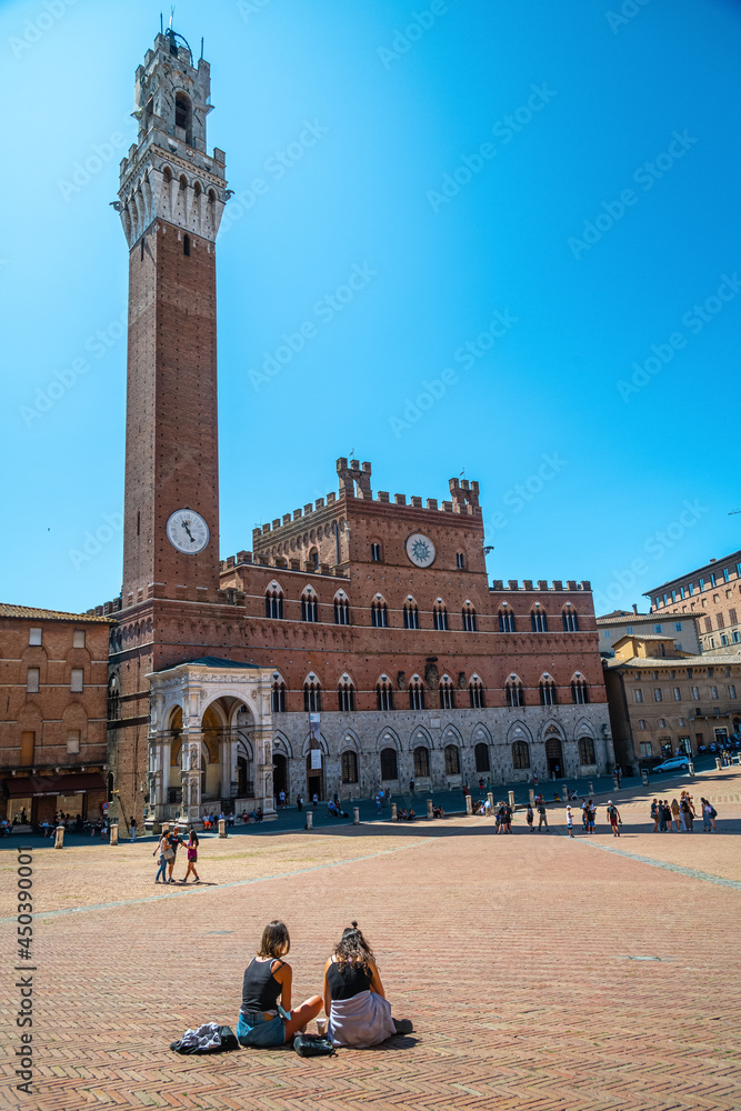 The Piazza del Campo, the public town square of the city of Siena, Tuscany, Italy, features the Palazzo Pubblico museum and its bell tower, the Torre del Mangia