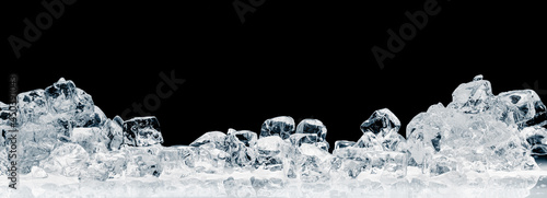 A heap of natural ice cubes on a black background. Purity and freshness concept background.