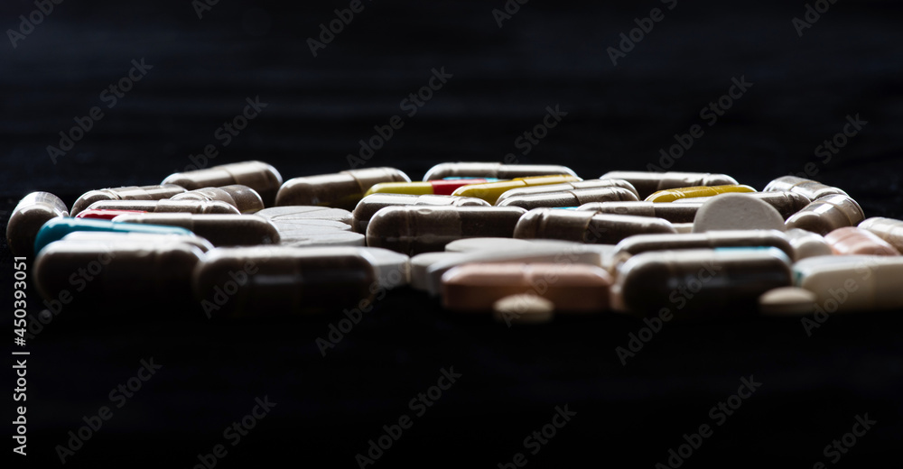 Starch capsule pills and tablets dark background, drugs Starch capsule pills and tablets dark background, drugs