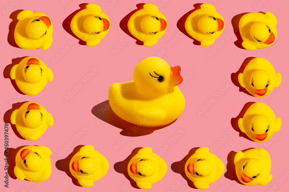 Rubber ducks on pink background.