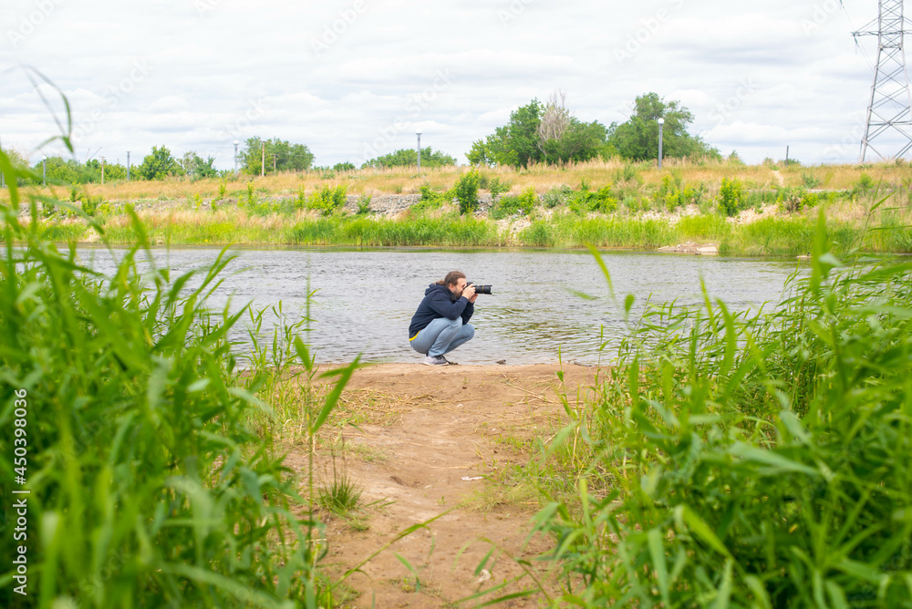 the photographer takes pictures of the vastness of the river the photographer takes pictures of the vastness of the river