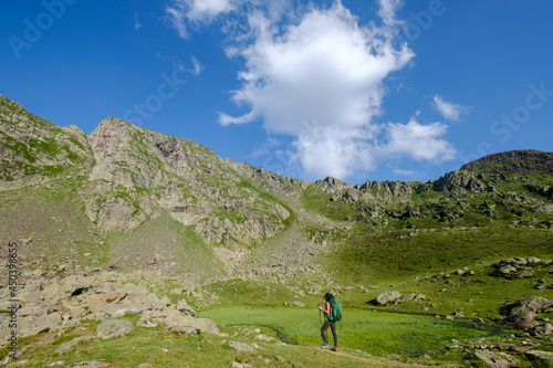 hiker on Lac Bersau  Ayous lakes tour  Pyrenees National Park  Pyrenees Atlantiques  France
