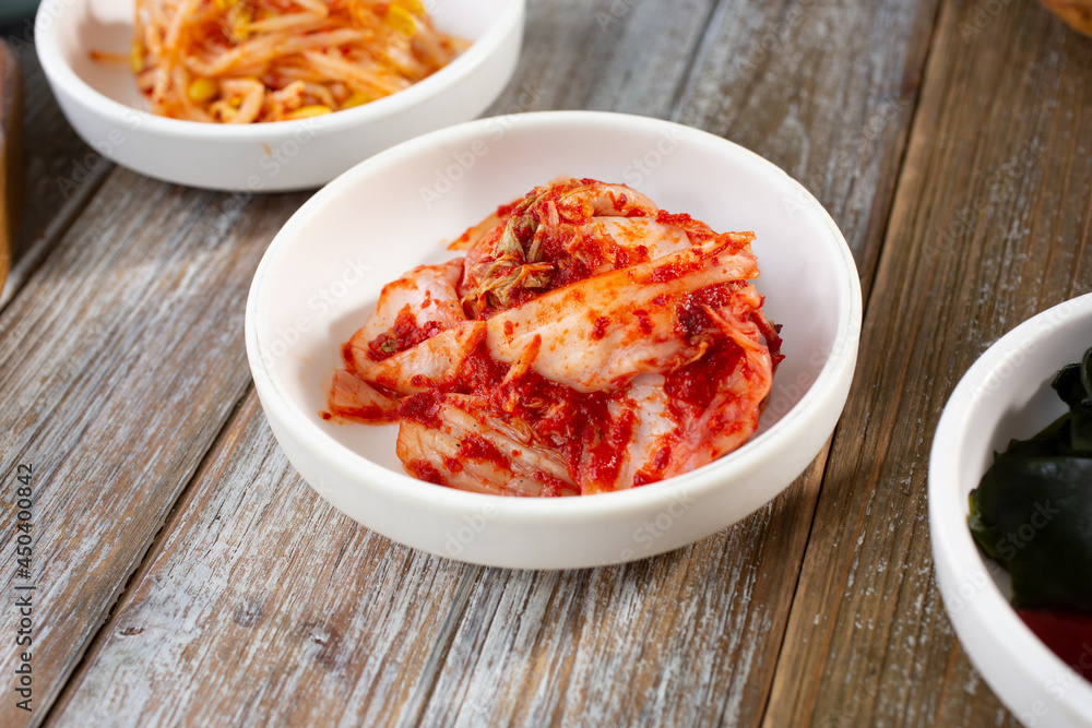 A view of several banchan dishes, featuring kimchi. A view of several banchan dishes, featuring kimchi.