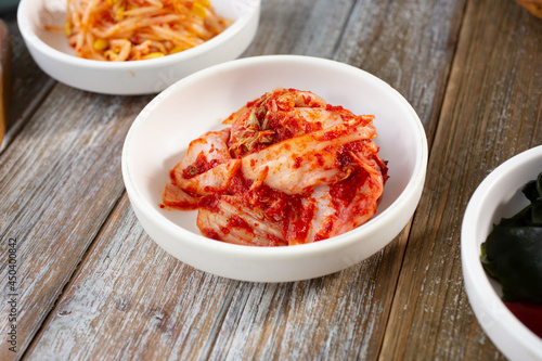 A view of several banchan dishes, featuring kimchi.