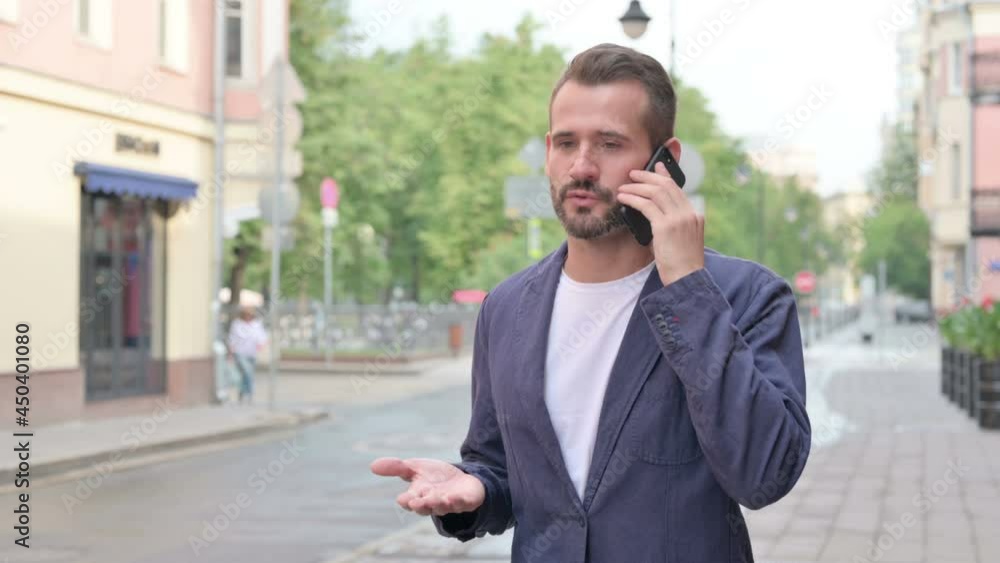Man Talking on Phone while Walking Down the Street Man Talking on Phone while Walking Down the Street