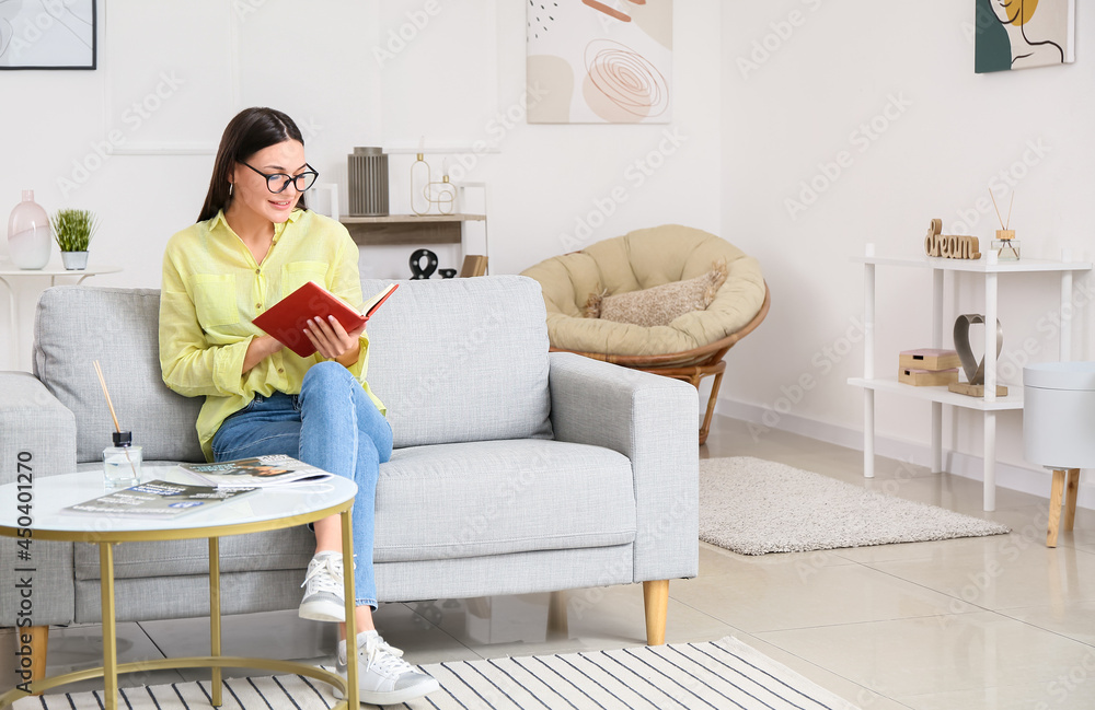 Young woman reading book at home Young woman reading book at home