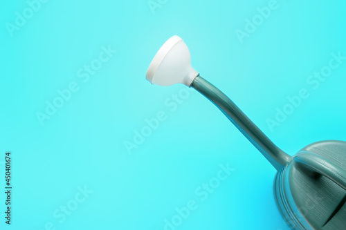 Watering can on color background, closeup