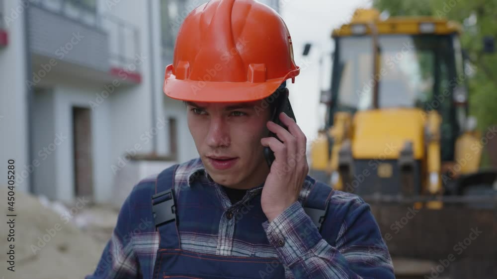 Close up young man talks on his phone Close up young man talks on his phone