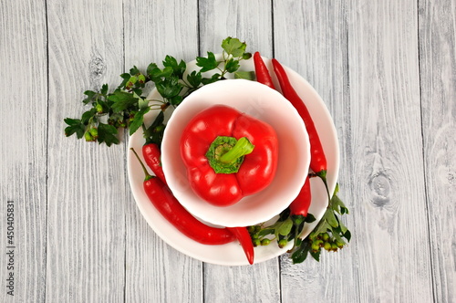 Red Bulgarian and Chili peppers on a white plate.