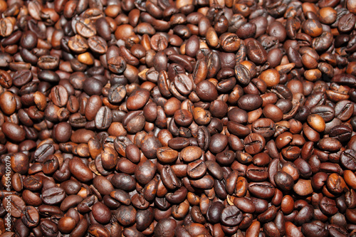 photo for background, roasted coffee beans of different shades of brown color close-up 