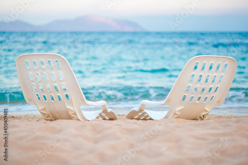 Landscape of Two Lonely beachchairs near the sea photo