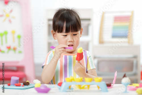 young girl making ice lolly using dough tools for homeschooling