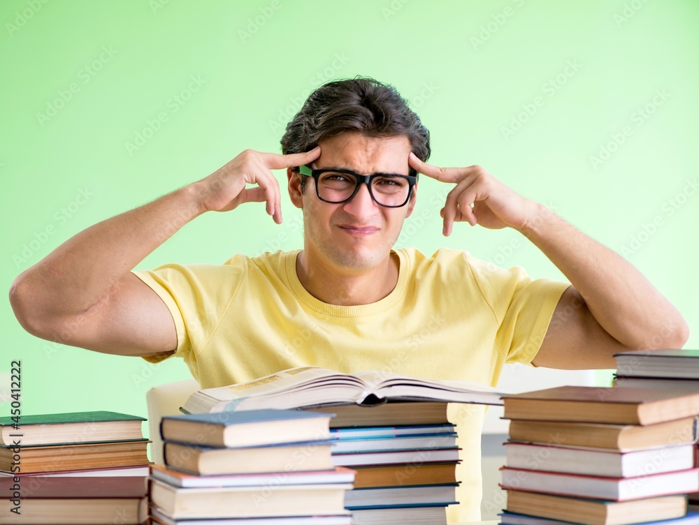 Student with too many books to read before exam Student with too many books to read before exam