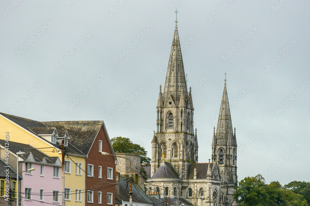 Fototapeta premium Towers of st Finbar's cathedral and rooftops of the surrounding buildings of the city of Cork, republic of Ireland