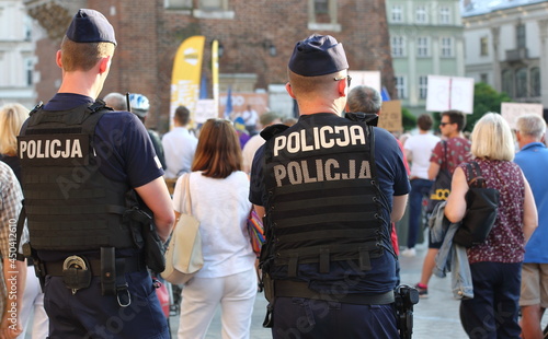 Policemen watching prostesting crowd in Poland