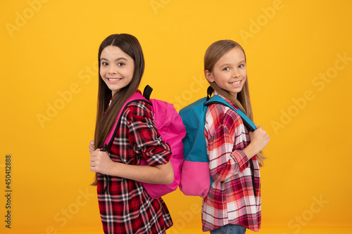 concept of education. kids with long hair on yellow background. september 1.