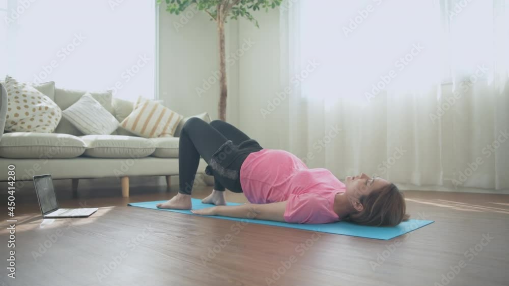 Pregnant woman concept of 4k Resolution. Asian women are exercising with hip lifts in the house. Pregnant woman concept of 4k Resolution. Asian women are exercising with hip lifts in the house.