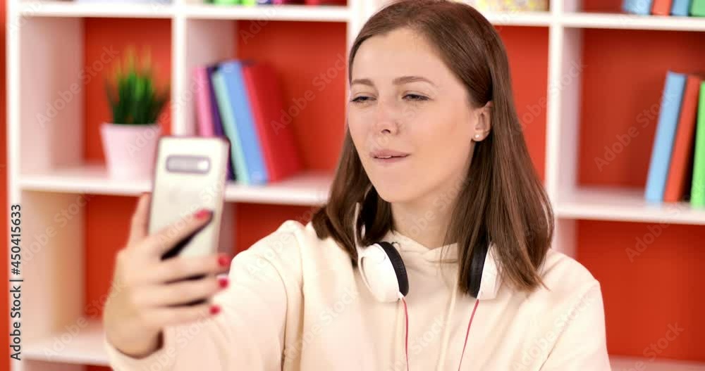 Businesswoman having video call discussing, working online meeting with team at home office. Beautiful woman making a video call smiling and talking with her friend and family.