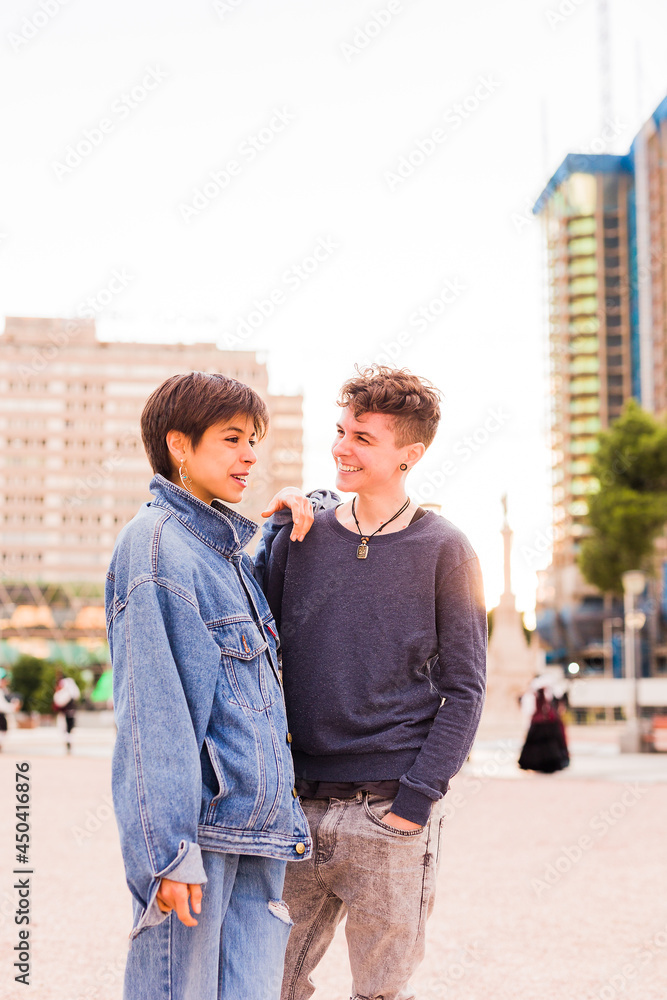 Young Tomboy lesbian couple. Androgynous non binary transgender and a hispanic woman with short hair Young Tomboy lesbian couple. Androgynous non binary transgender and a hispanic woman with short hair