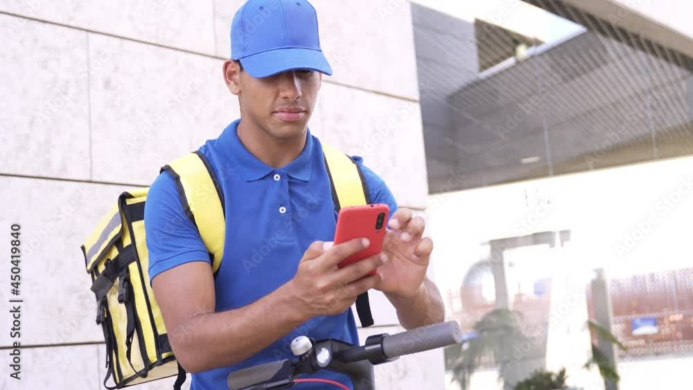 African delivery man using gps smartphone map app for food order riding electric scooter - Focus on courier man face African delivery man using gps smartphone map app for food order riding electric scooter - Focus on courier man face