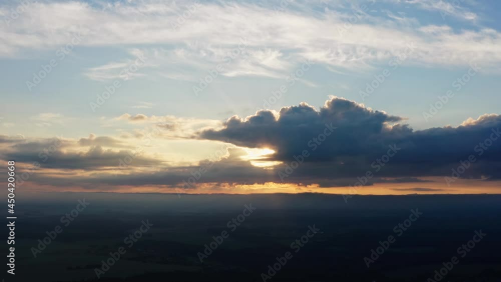 Aerial view of summer sunset or sunrise, sun beams and rainy clouds. Beautiful dawn. Idyllic landscape evening or morning. Drone flight from top to down Aerial view of summer sunset or sunrise, sun beams and rainy clouds. Beautiful dawn. Idyllic landscape evening or morning. Drone flight from top to down
