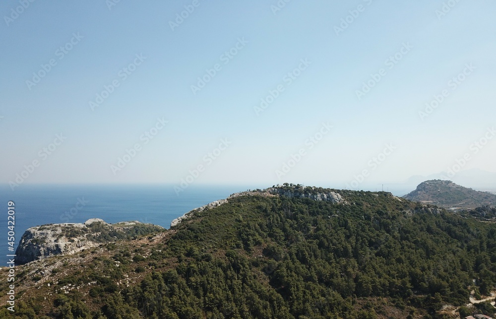 Obraz premium Greek mountains with blue sea in the background aerial drone photography