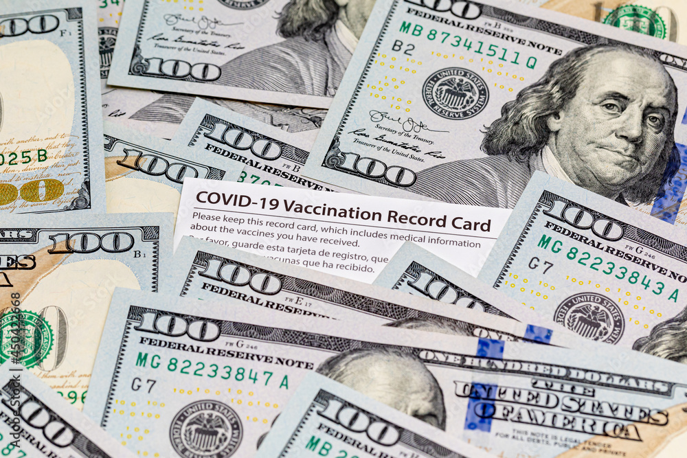 Covid-19 vaccination card and cash money. Covid vaccine lottery, bonus and incentive concept