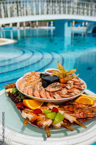 Seafood at a luxury resort overlooking the pool. Shrimp, lobster, crabs, fruit, crane sauce, soy sauce.