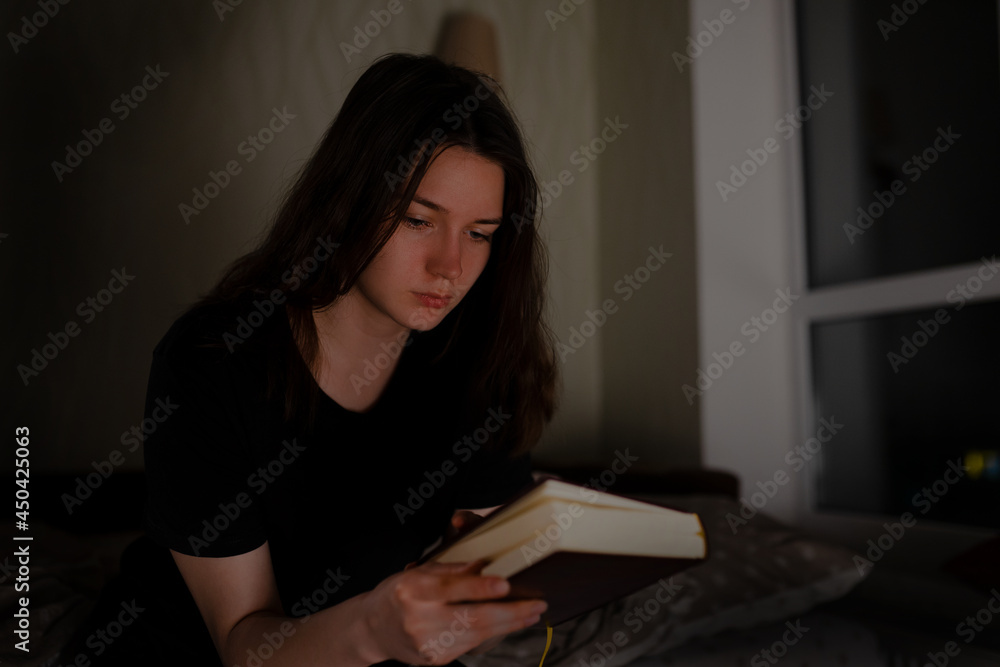 Woman reads the Bible at night Woman reads the Bible at night