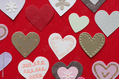 paper hearts on a deep red paper background