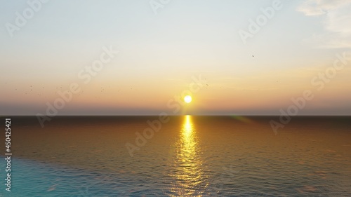 Romantic colorful sunset at the sea. The sun touches horizon. 