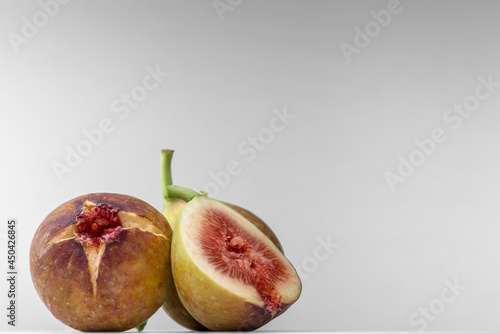 White background photo of figs cut in half. photo