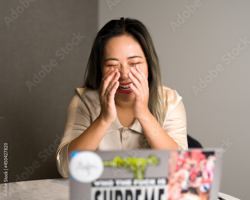 Young Asian Data Scientist Laughing in a Zoom Meeting