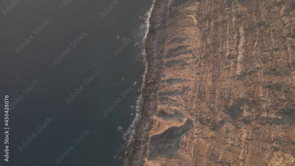 Overhead drone shot of brown cliffs and Sea waves hit on rocky coastline, beautiful landscape of a Fishing station. Overhead drone shot of brown cliffs and Sea waves hit on rocky coastline, beautiful landscape of a Fishing station.