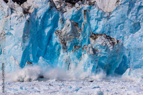 Blue ice falling from Columbia glacier calving into the ocean of Prince William Sound, Alaska. This glacier has been retreating since the early 1980'S