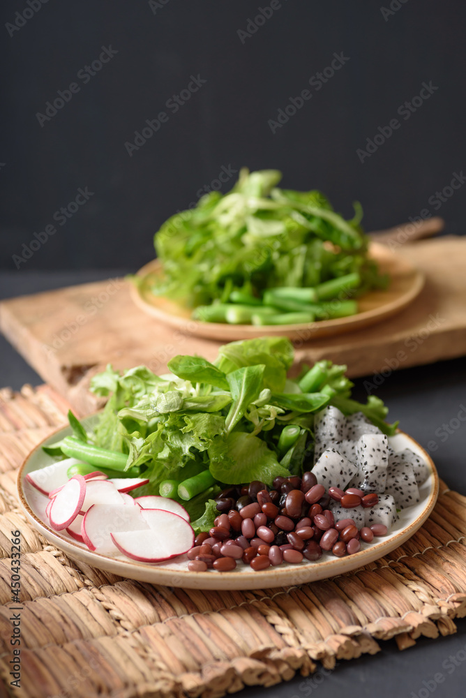 Fresh fruit and vegetable salad with kidney bean, azuki bean, green bean, dragon fruit, radish, lettuce and corn salad. Concepts of healthy food, vegetarian and lifestyle trends. Fresh fruit and vegetable salad with kidney bean, azuki bean, green bean, dragon fruit, radish, lettuce and corn salad. Concepts of healthy food, vegetarian and lifestyle trends.
