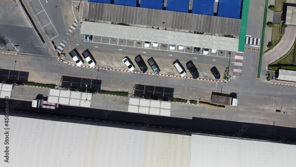 4K on Factory roof from aerial bird eyes view tracking of car and trucks in warehouse. Area of large plant from top view with space of industrial and green area around. 4K on Factory roof from aerial bird eyes view tracking of car and trucks in warehouse. Area of large plant from top view with space of industrial and green area around.