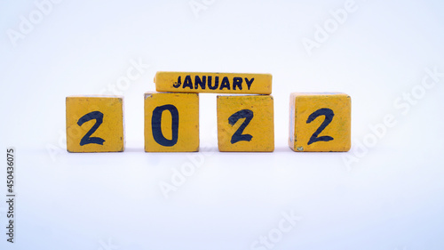 Wooden block calendar for January 2022. Yellow on a white background