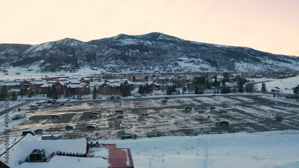 Almost Empty Parking Lot At The Ski Resort Of Steamboat In Steamboat Springs, Routt County, Colorado USA. - Aerial Tilt-Up Drone Shot Almost Empty Parking Lot At The Ski Resort Of Steamboat In Steamboat Springs, Routt County, Colorado USA. - Aerial Tilt-Up Drone Shot