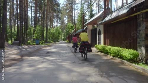 Wallpaper Mural Young cyclists ride along a picturesque road past the village. Two young men with backpacks ride bicycles along the road. Torontodigital.ca