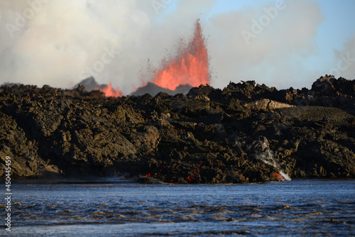 The 2014 Bárðarbunga eruption at the Holuhraun fissures and its advancing lava flow as seen from across a glacial river, Central Highlands, Iceland
