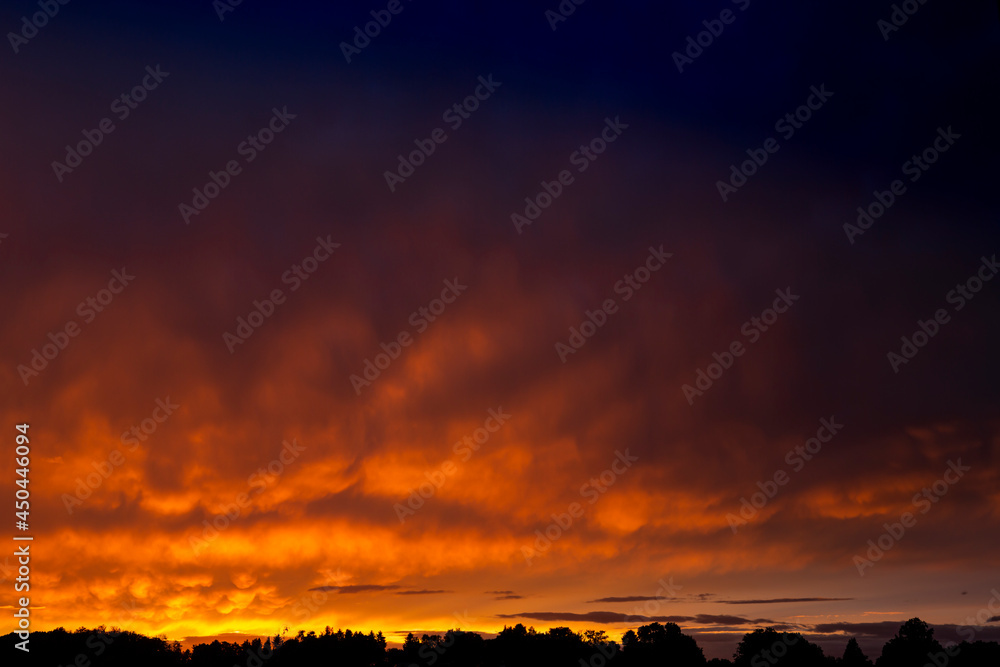 Amazing and dramatic sunset colors during a rainy day in summer Amazing and dramatic sunset colors during a rainy day in summer