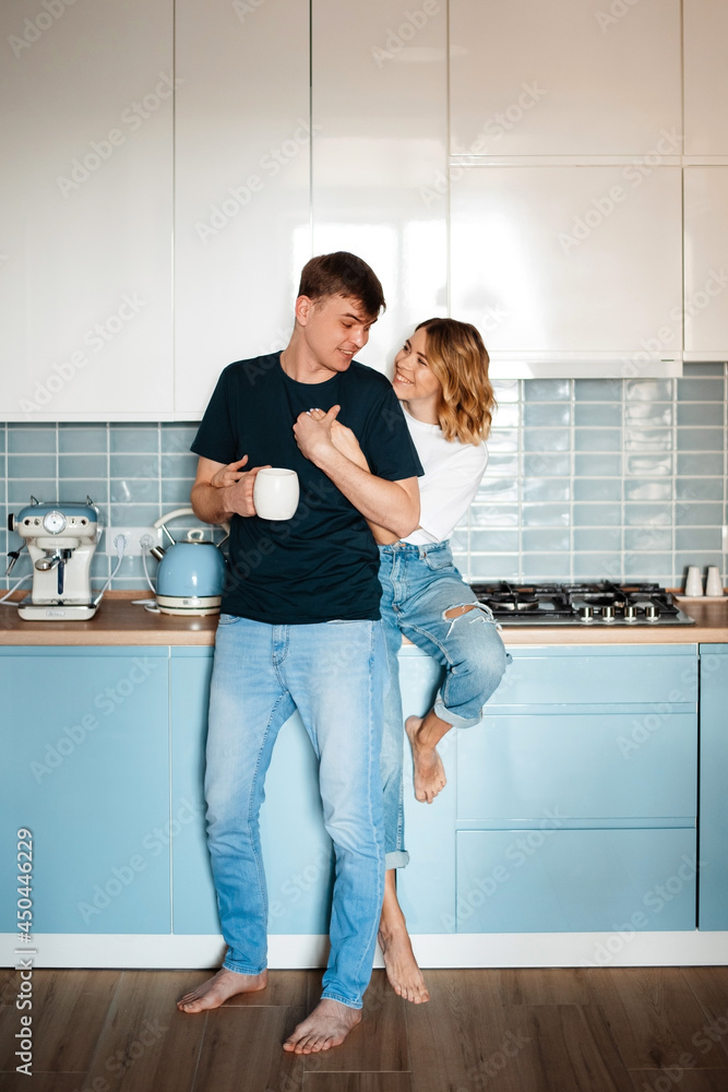 Smiling woman hugging her boyfriend that drinking coffee Smiling woman hugging her boyfriend that drinking coffee